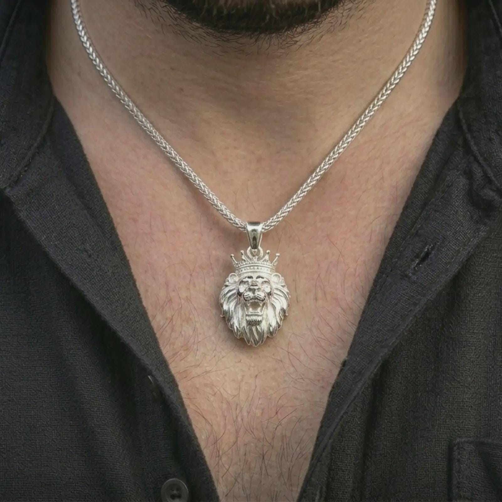 Polished silver crowned lion head pendant necklace worn on the neck, shown against the chest in a clean and striking everyday wear composition.
