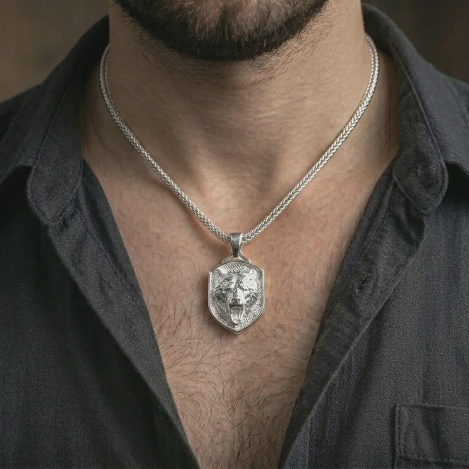 Polished silver roaring bear shield pendant necklace worn on the neck, shown against the chest in a clean and striking everyday wear composition.