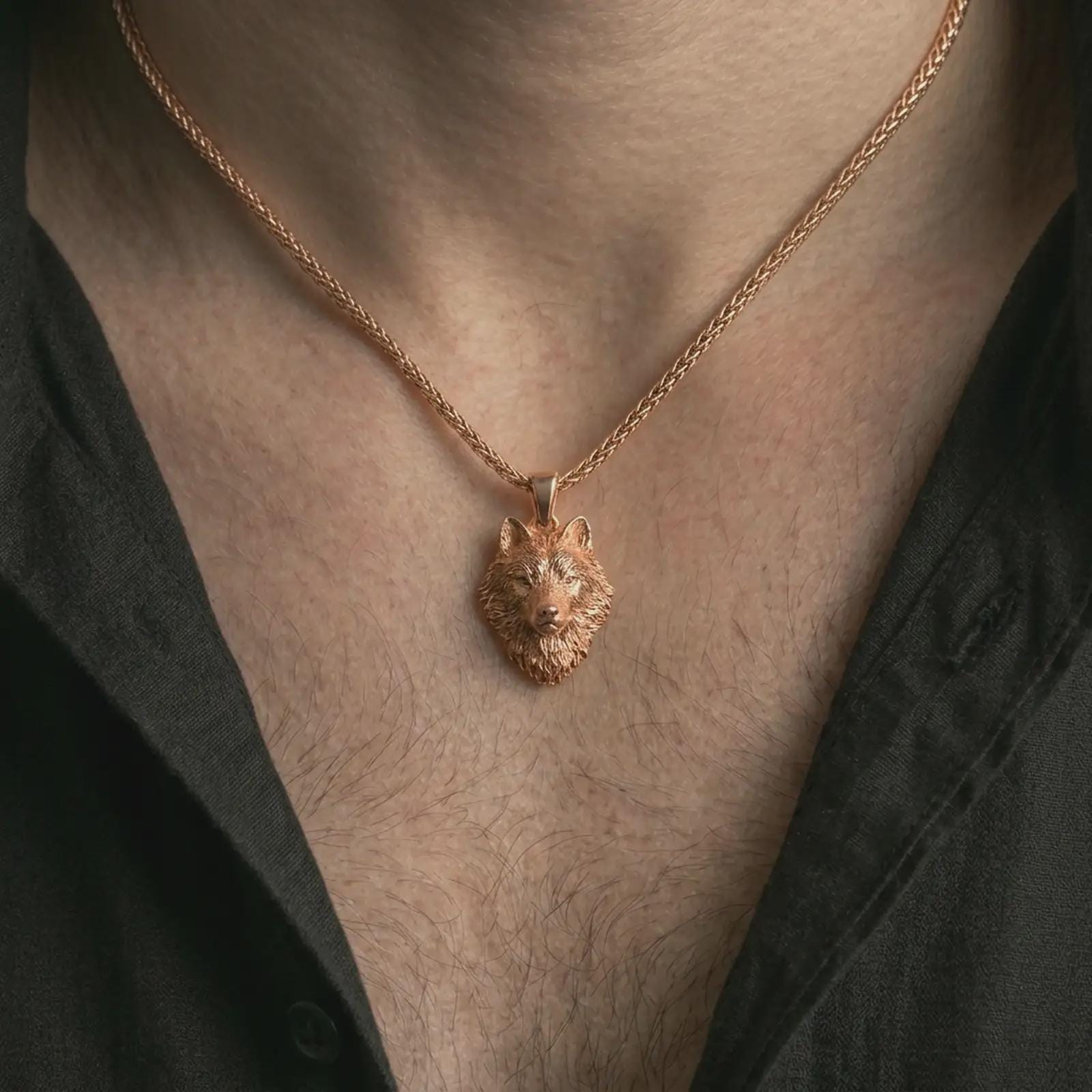 Rose gold plated wolf head pendant necklace worn on the neck, presented in a close-up lifestyle shot with a refined wildlife-inspired aesthetic.