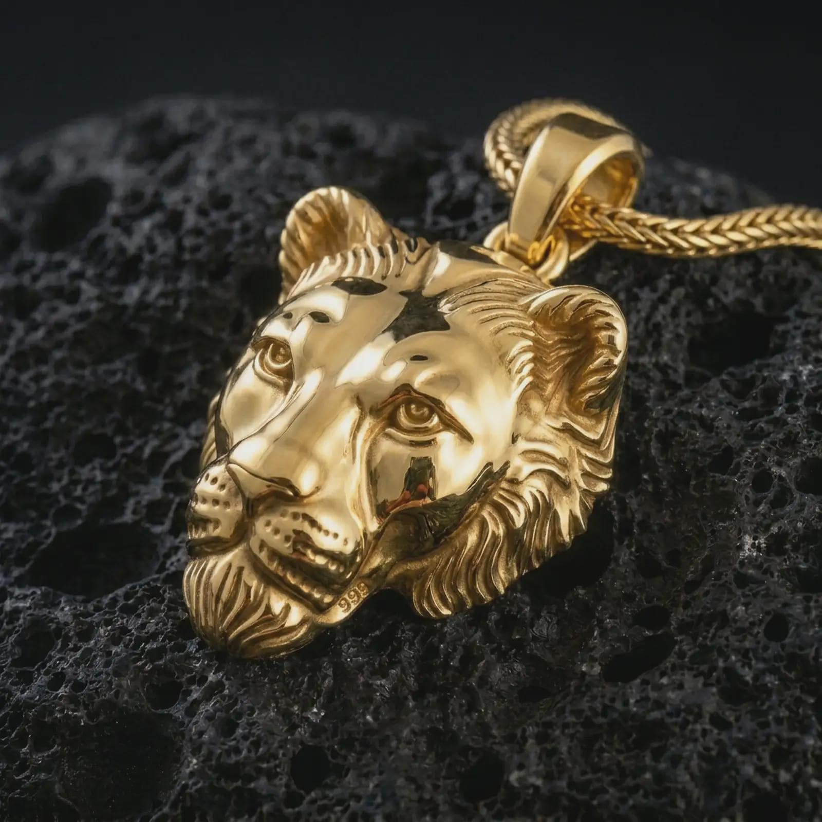 Gold plated 3D lioness pendant necklace presented on porous volcanic rock, highlighting the fierce animal charm in a luxurious close-up jewelry image.