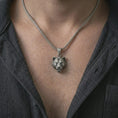 Load image into Gallery viewer, Oxidized 3D lioness pendant necklace worn on the neck, styled in a dark lifestyle portrait with an open shirt and bold feminine predator presentation.
