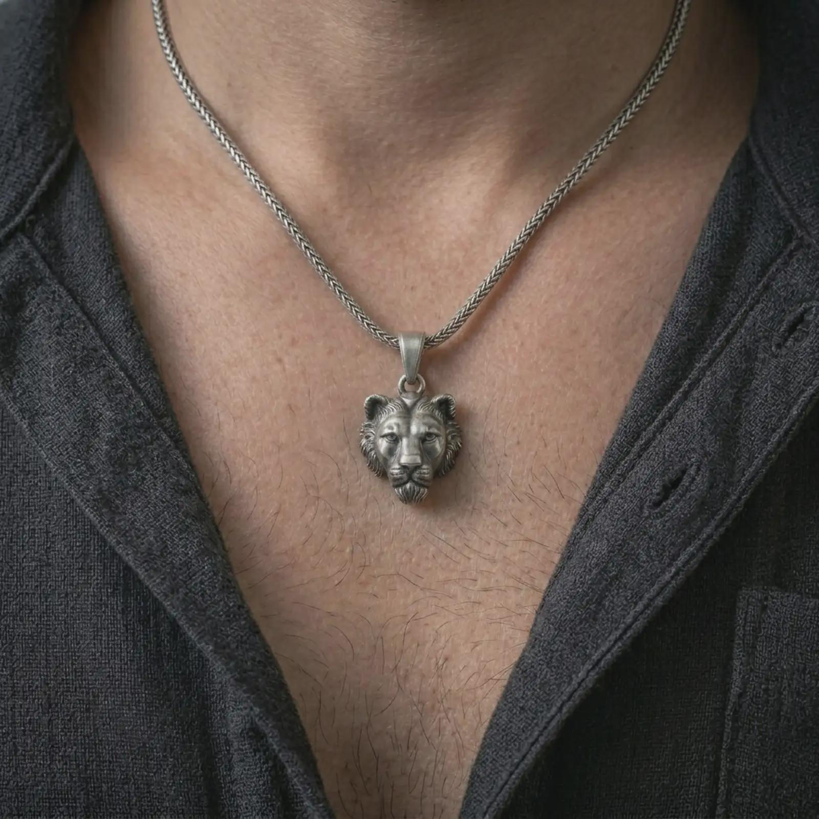 Oxidized 3D lioness pendant necklace worn on the neck, styled in a dark lifestyle portrait with an open shirt and bold feminine predator presentation.