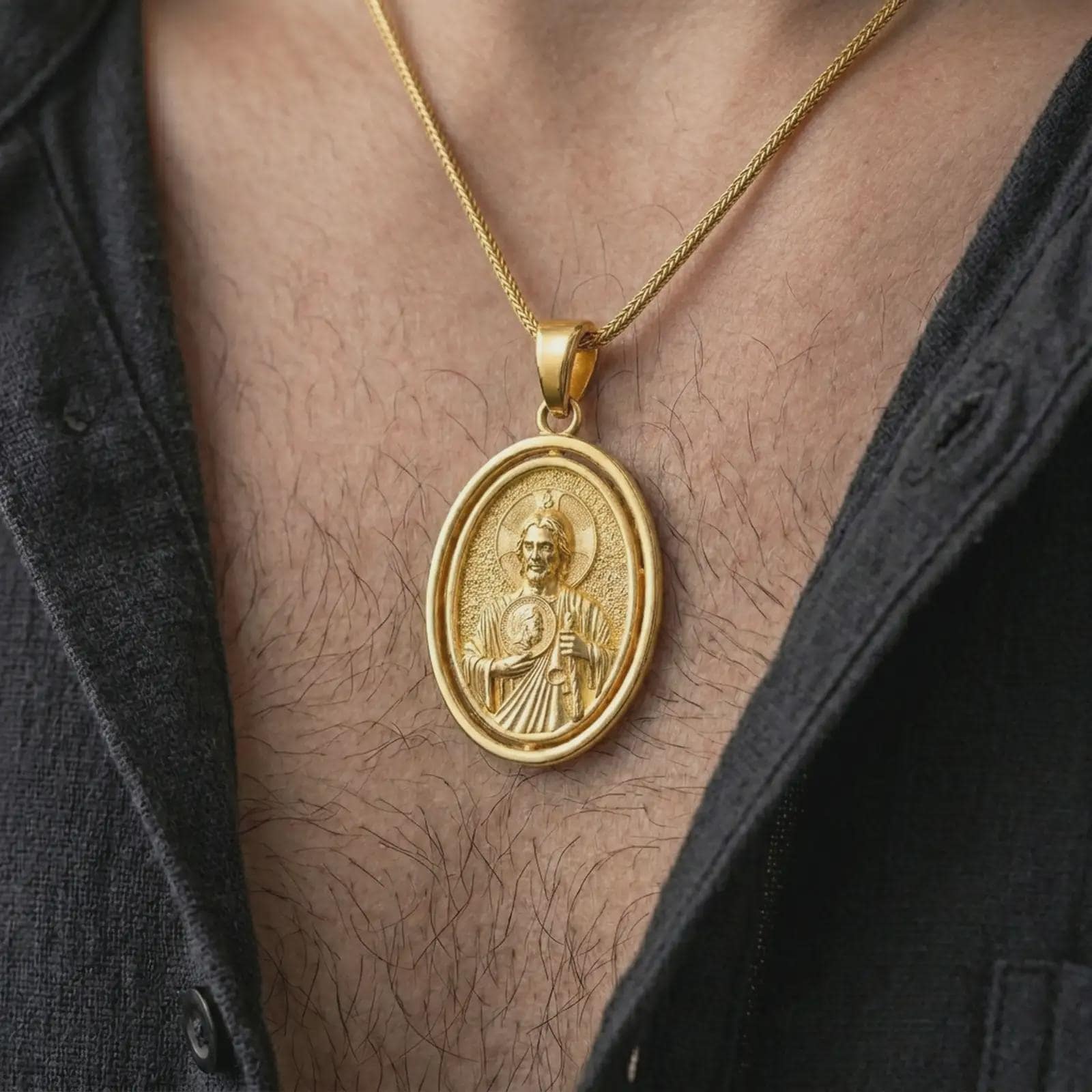 Gold plated Saint Jude pendant necklace worn on the chest, premium lifestyle jewelry photo with the Saint Jude medal centered on a spiga chain.