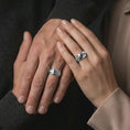 Load image into Gallery viewer, A sterling silver ring with a polished silver finish and marquise blue stone worn on a finger in a clean lifestyle close-up.
