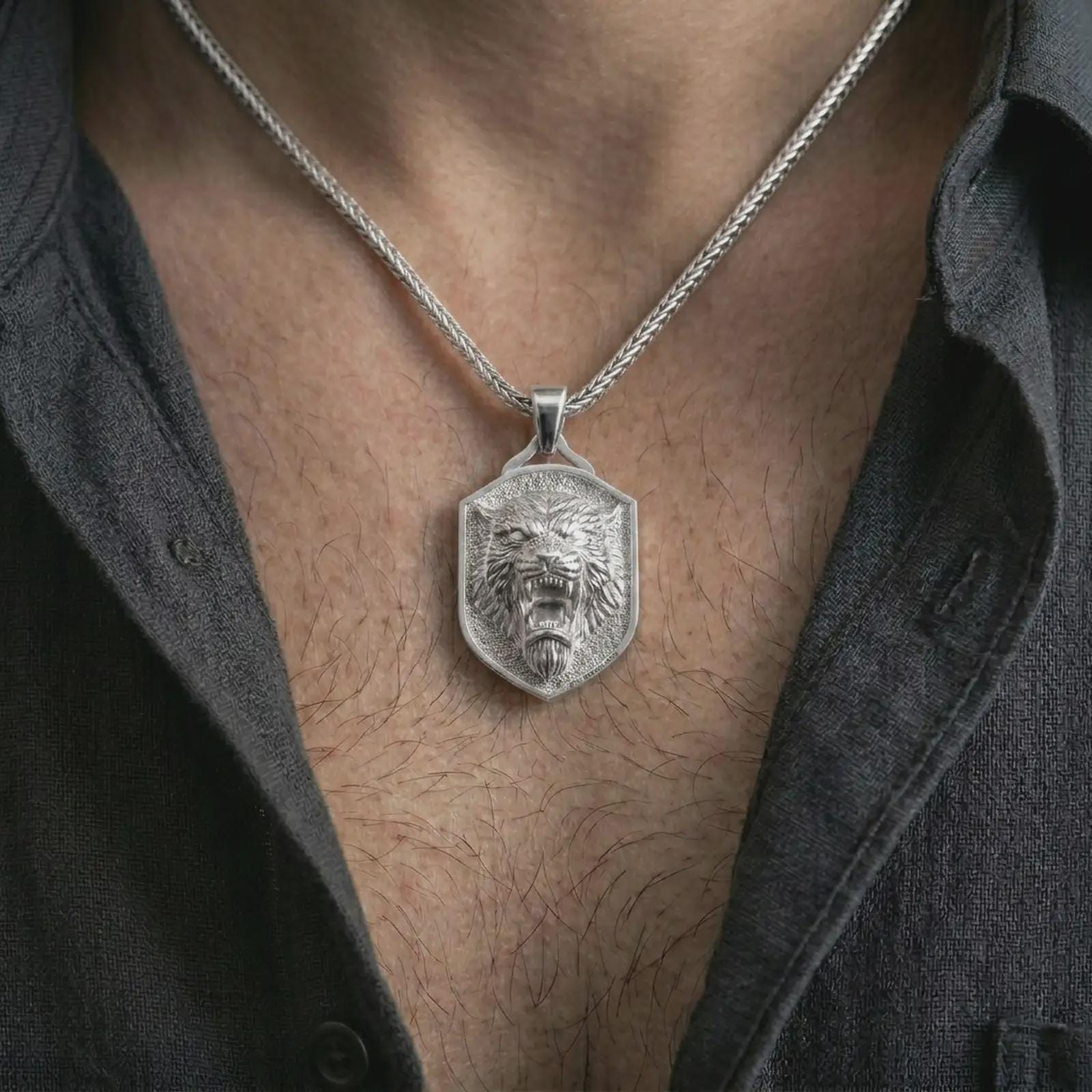 Polished silver roaring lion shield pendant necklace worn on the neck, shown against the chest in a clean and striking everyday wear composition.