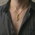 Load image into Gallery viewer, Gold plated Pegasus wing horse pendant necklace worn on the neck, captured on a human model in a premium dark-toned lifestyle frame.
