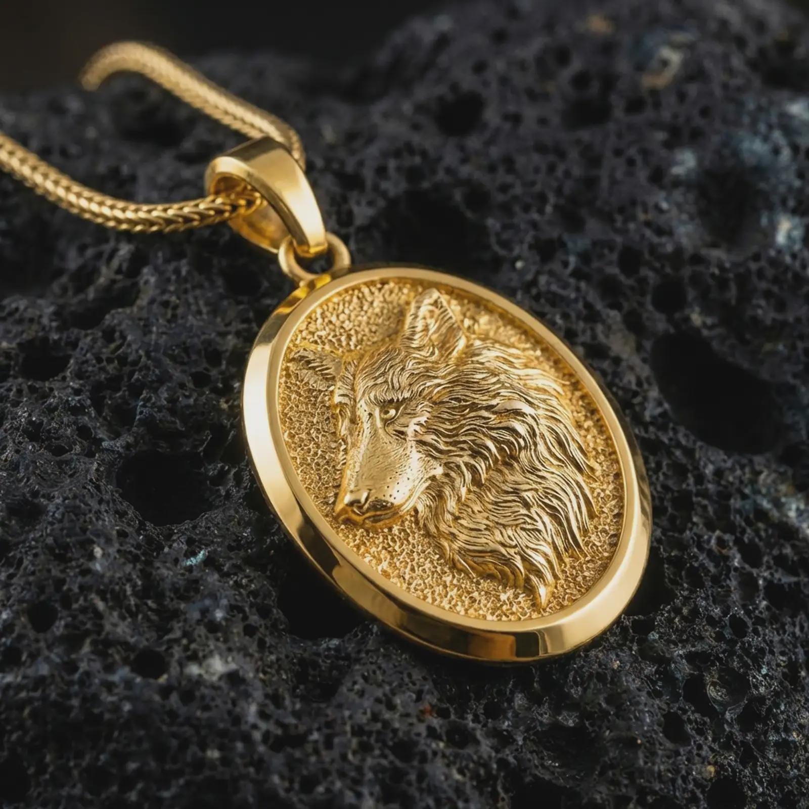 Gold plated wolf medallion pendant necklace presented on porous volcanic rock, highlighting the wild forest guardian motif in a luxurious close-up jewelry image.