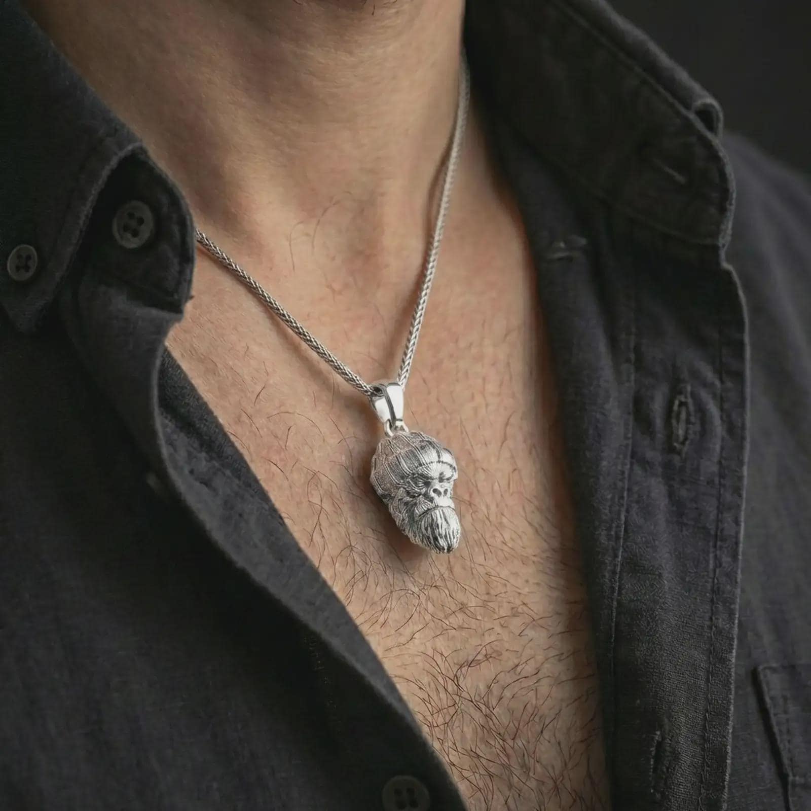 Polished silver gorilla head pendant necklace worn on the neck, shown against the chest in a clean and striking everyday wear composition.