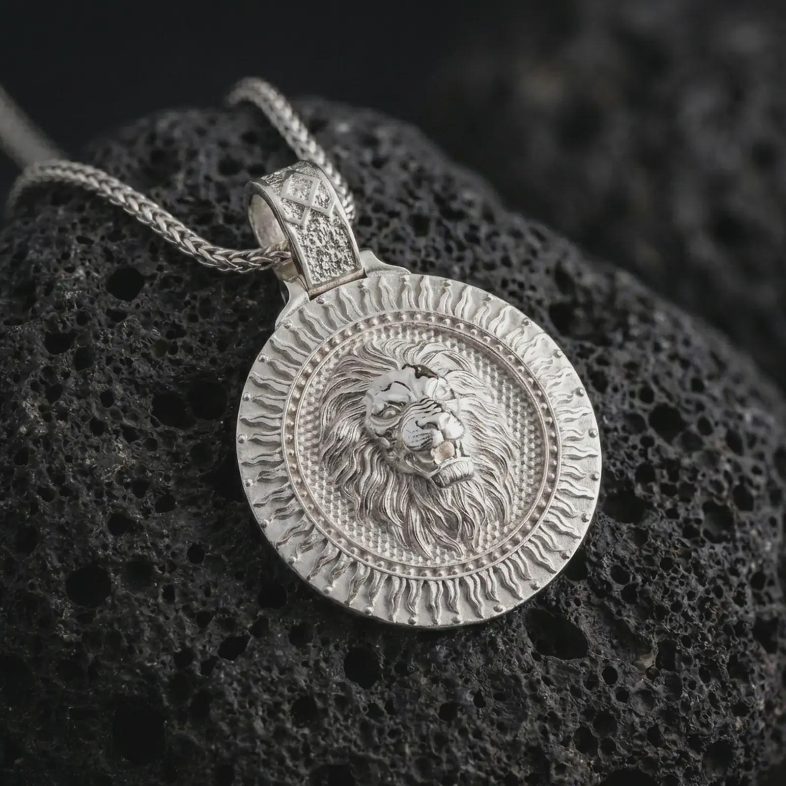 Polished silver Viking lion medallion pendant necklace displayed on black volcanic rock, shown in a refined macro product shot with roaring lion relief, radiant sunburst border, and Othala rune inspired bail detail.