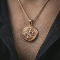 Load image into Gallery viewer, Rose gold plated lion medallion pendant necklace worn on the neck, shown in a close-up model photograph with a refined symbolic and royal appearance.

