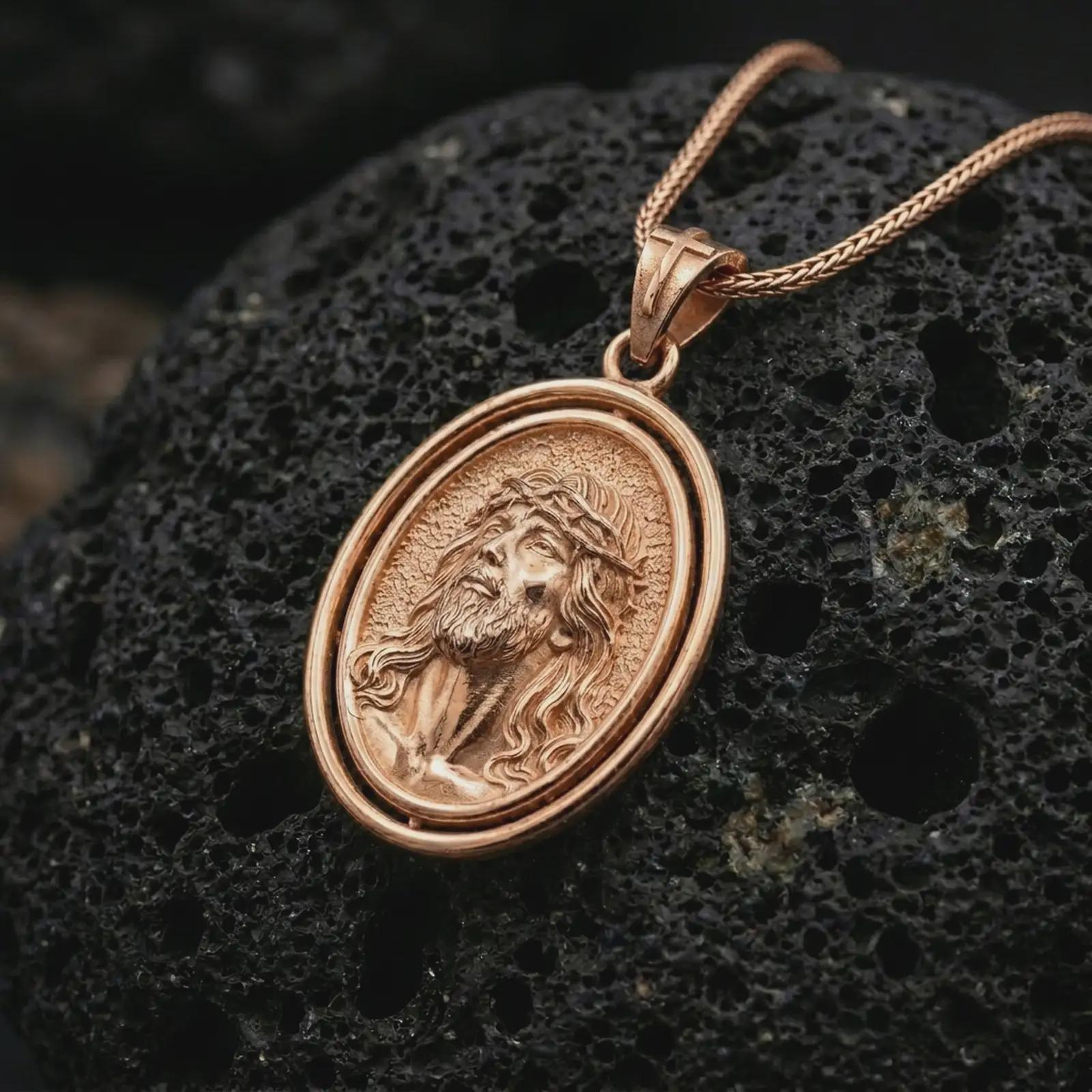 Rose gold plated spinning Jesus Christ pendant necklace on textured volcanic rock, detailed macro product shot with soft warm reflections and sacred Christian symbolism.