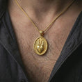 Load image into Gallery viewer, Gold plated Sacred Heart pendant necklace worn on the chest, premium lifestyle jewelry photo with the Sacred Heart medal centered on a spiga chain.
