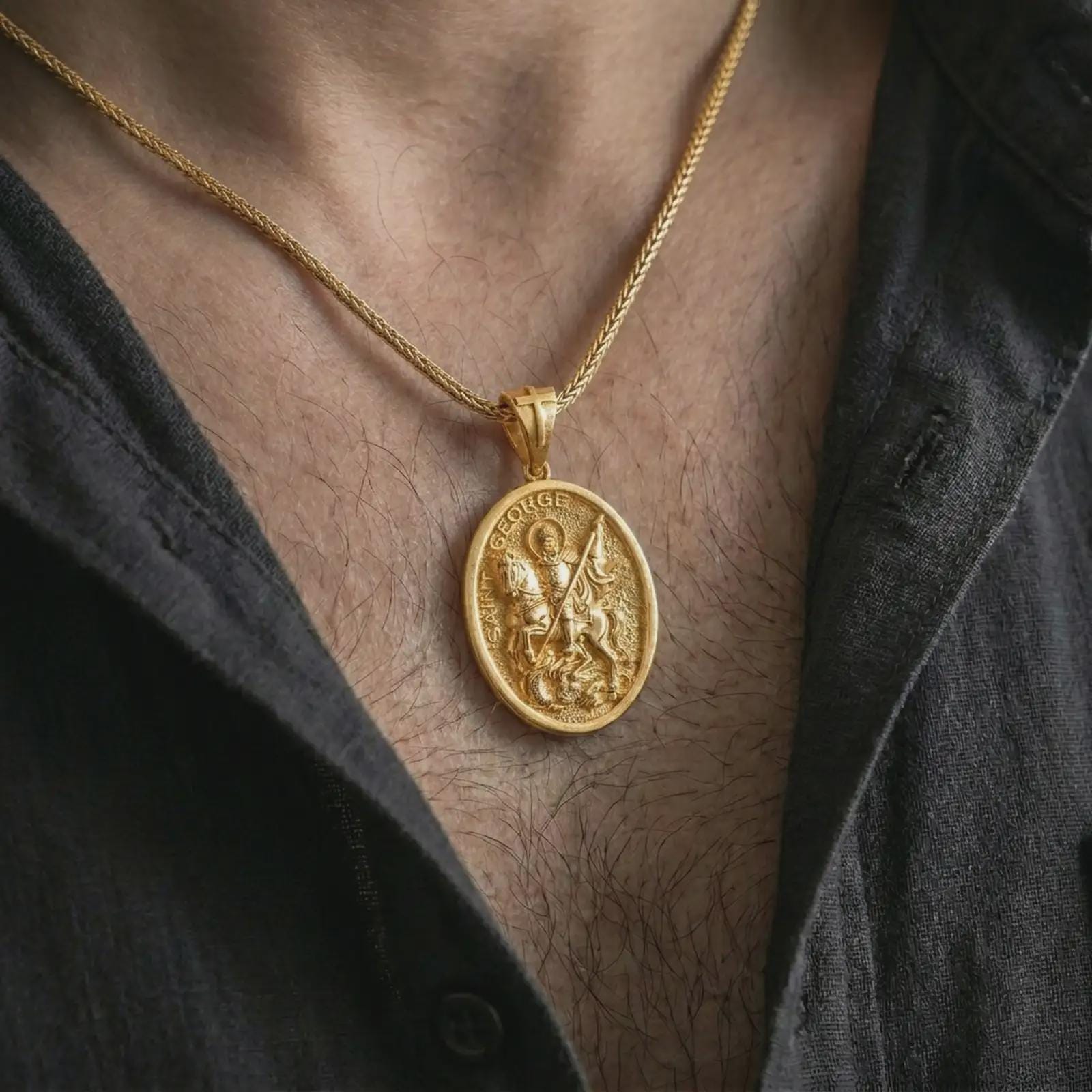 Gold plated Saint George pendant necklace worn on the chest, premium lifestyle jewelry photo with the Saint George medal centered on a spiga chain.