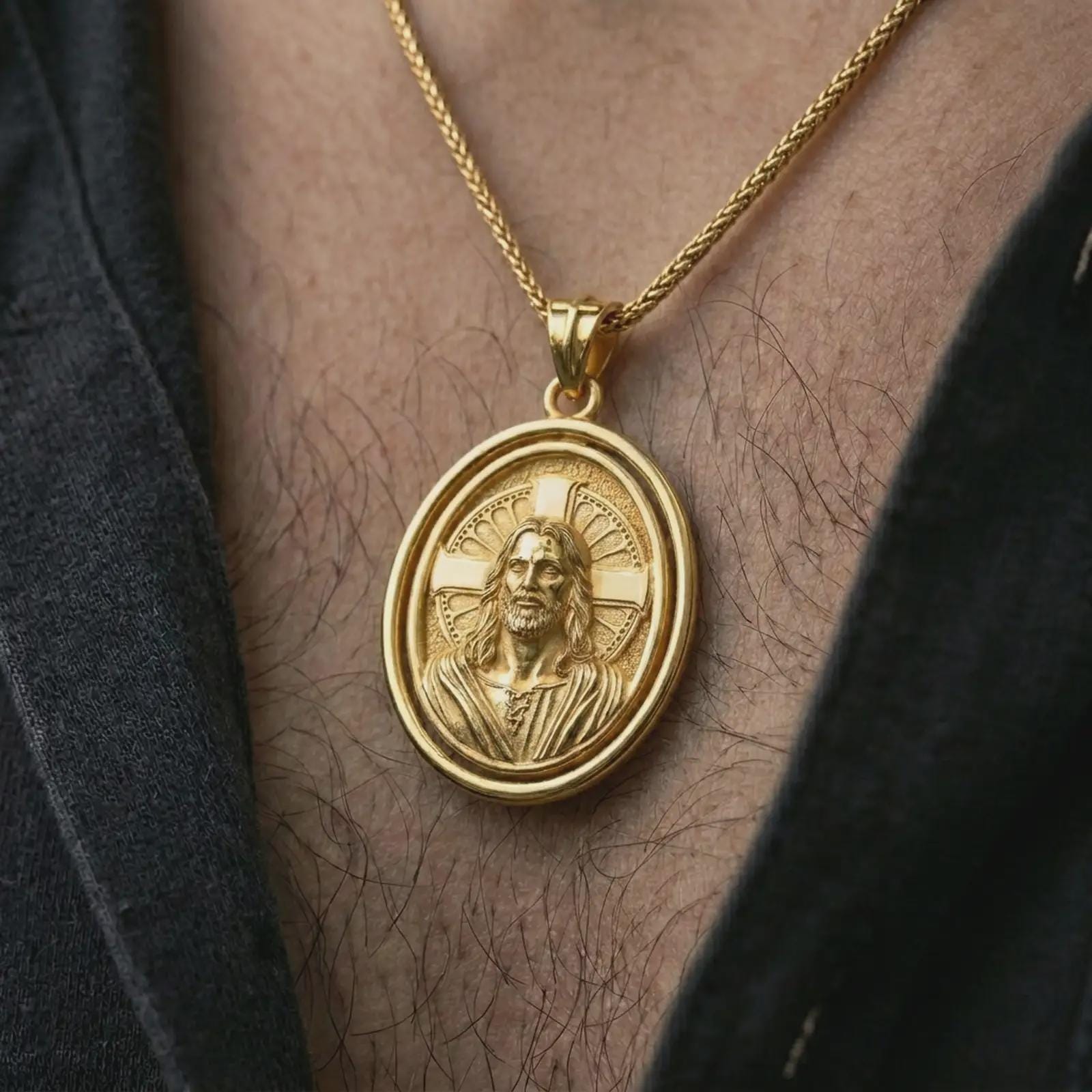 Gold plated spinning Jesus Christ pendant necklace worn on the chest, premium lifestyle jewelry photo with the rotating Jesus Christ medal centered on a spiga chain.