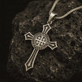 Load image into Gallery viewer, Bronze Knights Templar cross pendant necklace with an oxidized finish resting on textured volcanic rock, captured in a close-up studio image with the Sigillum Militum Xpisti seal at the center.
