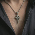 Load image into Gallery viewer, Oxidized Celtic cross pendant necklace worn on the neck, styled in a dark lifestyle image that highlights the historic Christian symbol against the chest.
