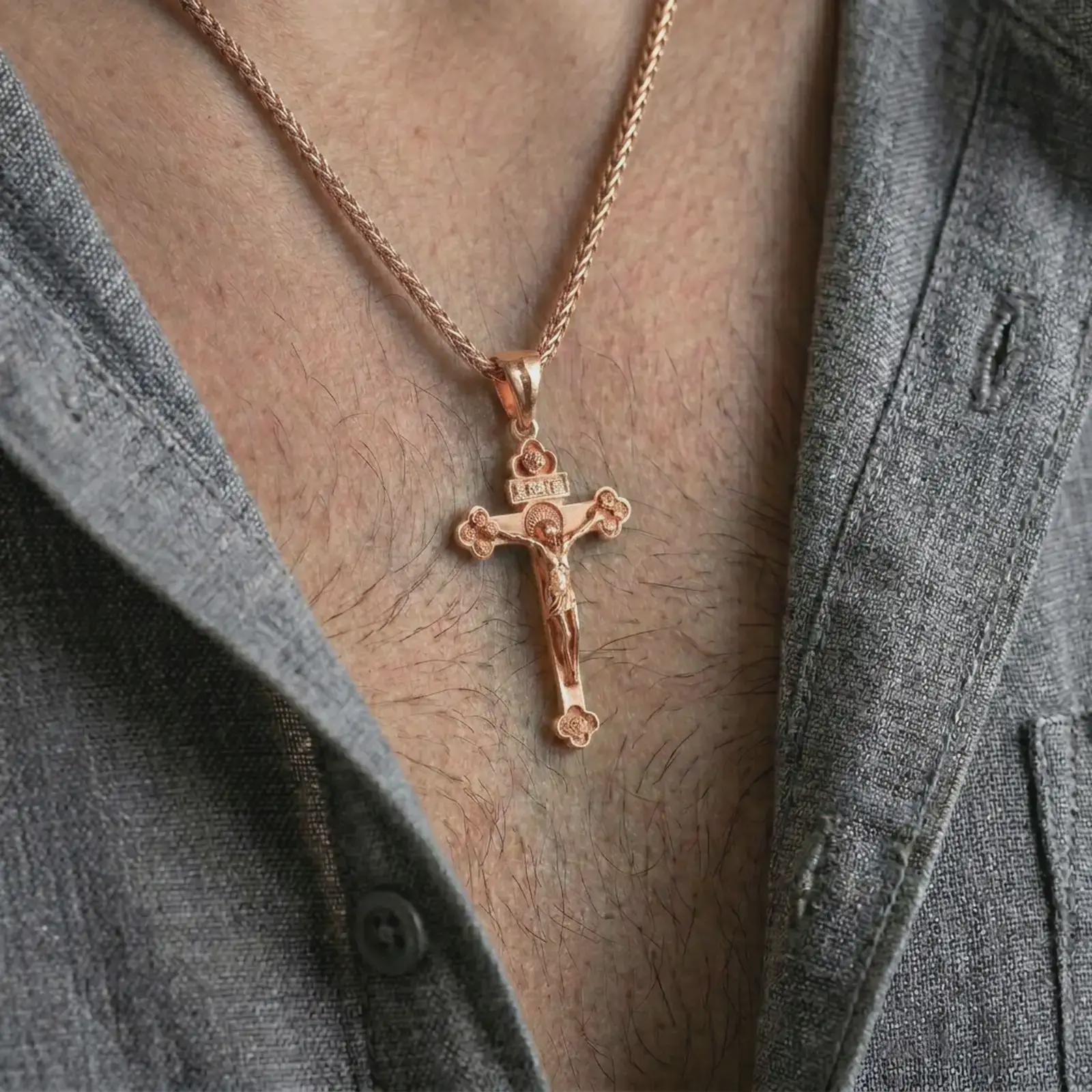 Rose gold plated crucifix pendant necklace worn on the neck, shown in a refined model photograph with an elegant Christian and devotional inspired look.