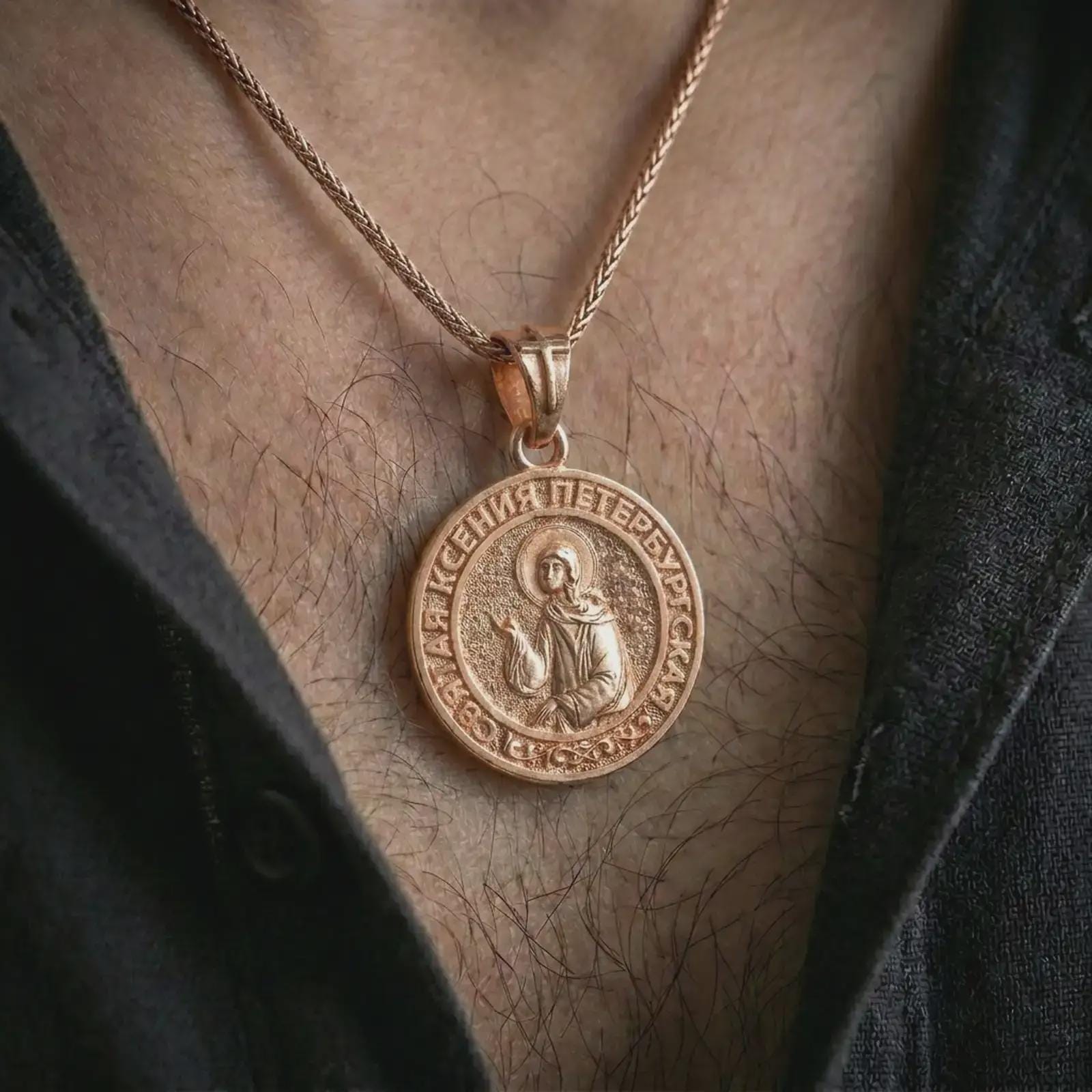 Rose gold plated Saint Xenia pendant necklace worn on the neck, shown in an elegant model photograph with a sacred and devotional Orthodox jewelry look.