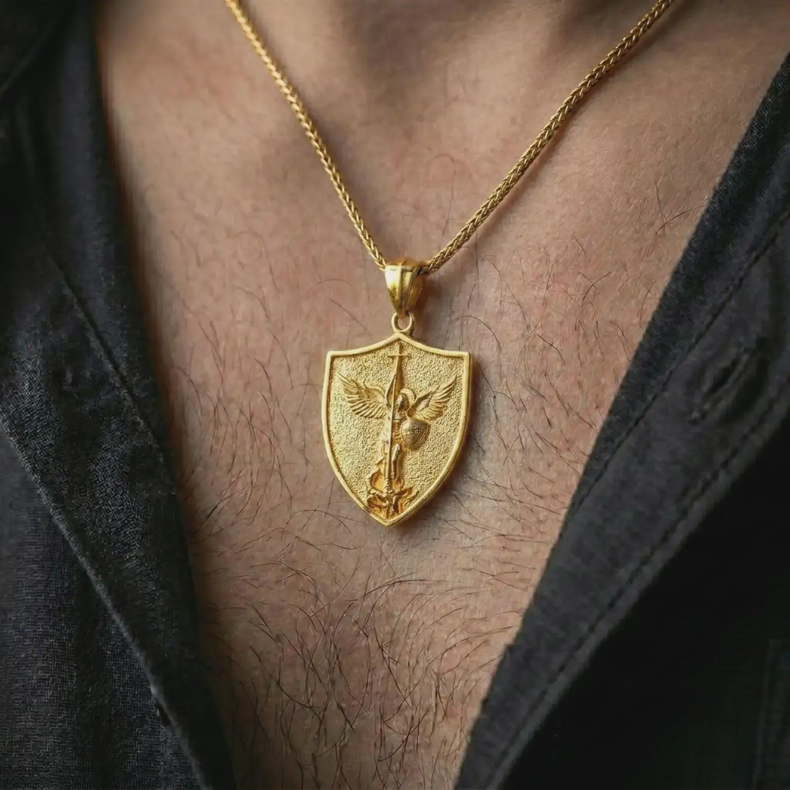 Gold plated Saint Michael pendant necklace worn on the neck, captured in a premium lifestyle composition that highlights the warrior angel motif as a meaningful Christian statement piece.