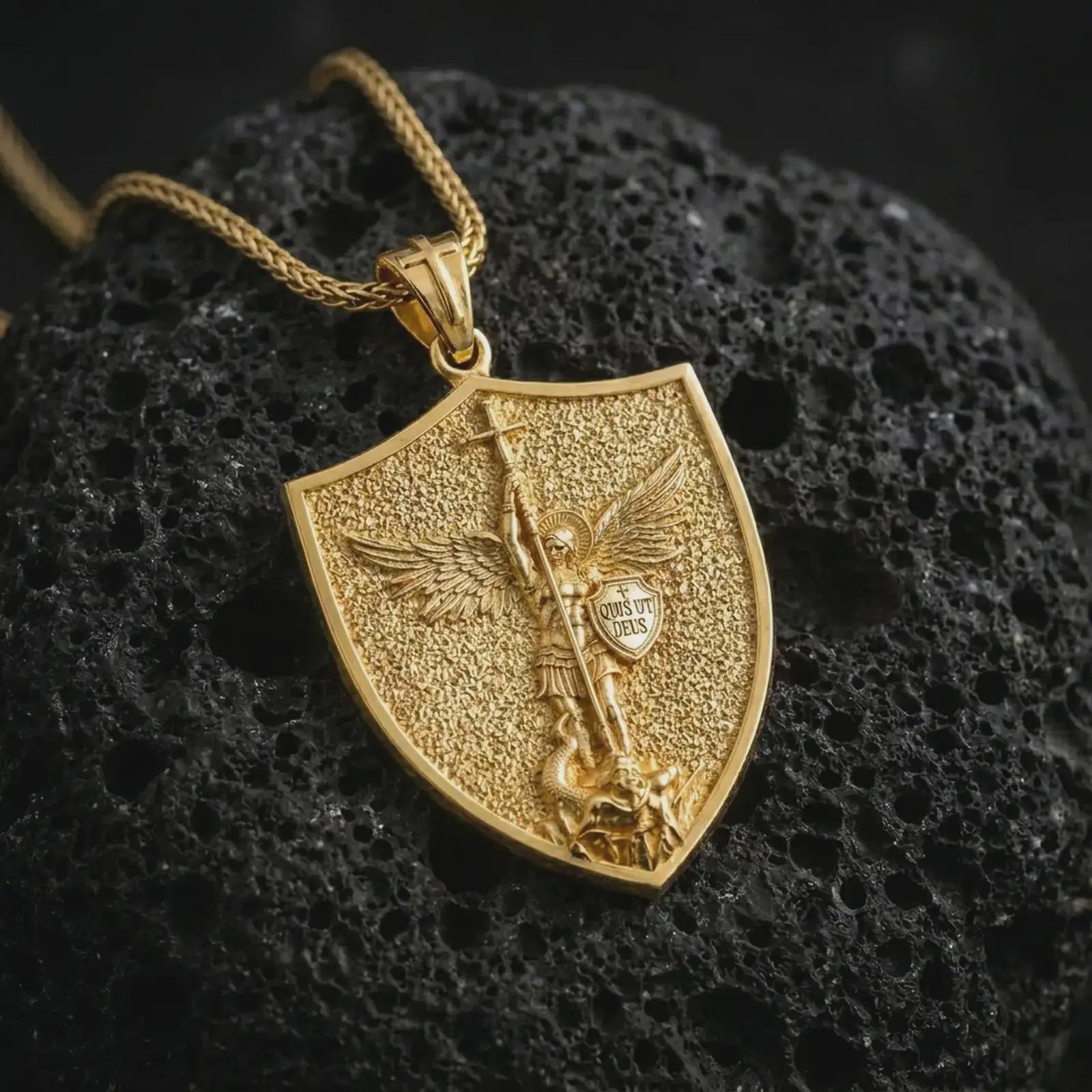 Gold plated Saint Michael pendant necklace presented on textured black volcanic stone, showcasing the warrior angel design and symbolic Christian protection details in a luxury macro shot.