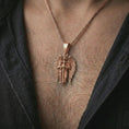 Load image into Gallery viewer, Rose gold plated angel warrior pendant necklace worn on the neck, presented in a premium model photograph with a strong spiritual aesthetic and striking symbolic presence.
