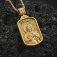 Load image into Gallery viewer, Gold plated Saint Jude dog tag pendant necklace on textured volcanic rock, premium close-up studio composition emphasizing the saint figure, halo, and sacred medallion symbolism.
