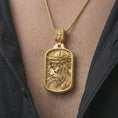Load image into Gallery viewer, Gold plated crucified Jesus dog tag pendant necklace worn on the chest, premium lifestyle jewelry photo with the crucified Jesus portrait medal centered on a spiga chain.

