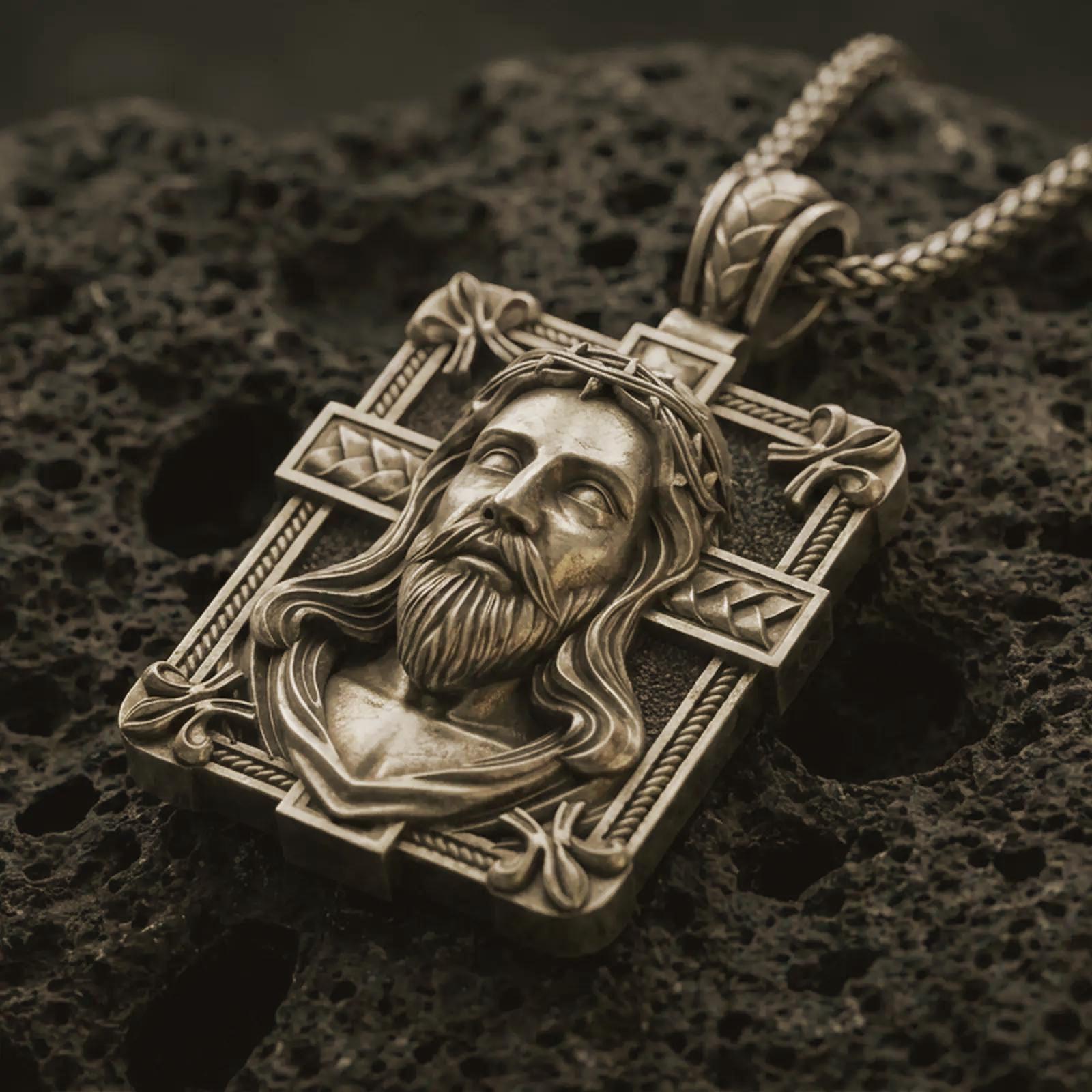 A Bronze Jesus crucifix pendant in an oxidized finish resting on porous volcanic rock in a premium macro studio shot.