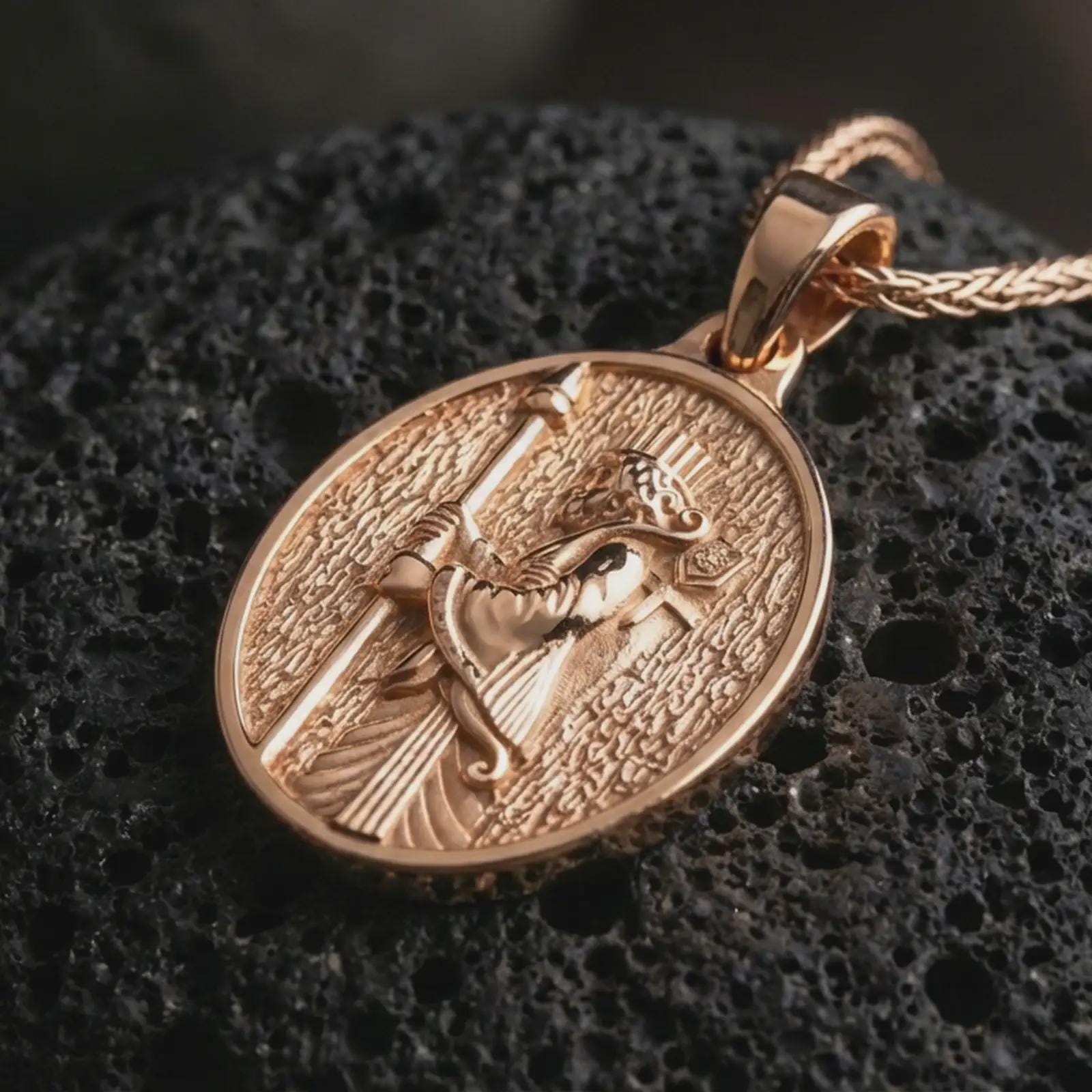 Rose gold plated Achaemenid soldier pendant necklace on dark volcanic rock, shown in a detailed premium macro view with the regal soldier relief and textured antique-inspired frame.