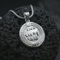 Load image into Gallery viewer, Polished silver Emperor Constans coin pendant necklace displayed on dark volcanic rock, shown in a premium close-up image that highlights the classical emperor portrait and ancient Roman coin texture.
