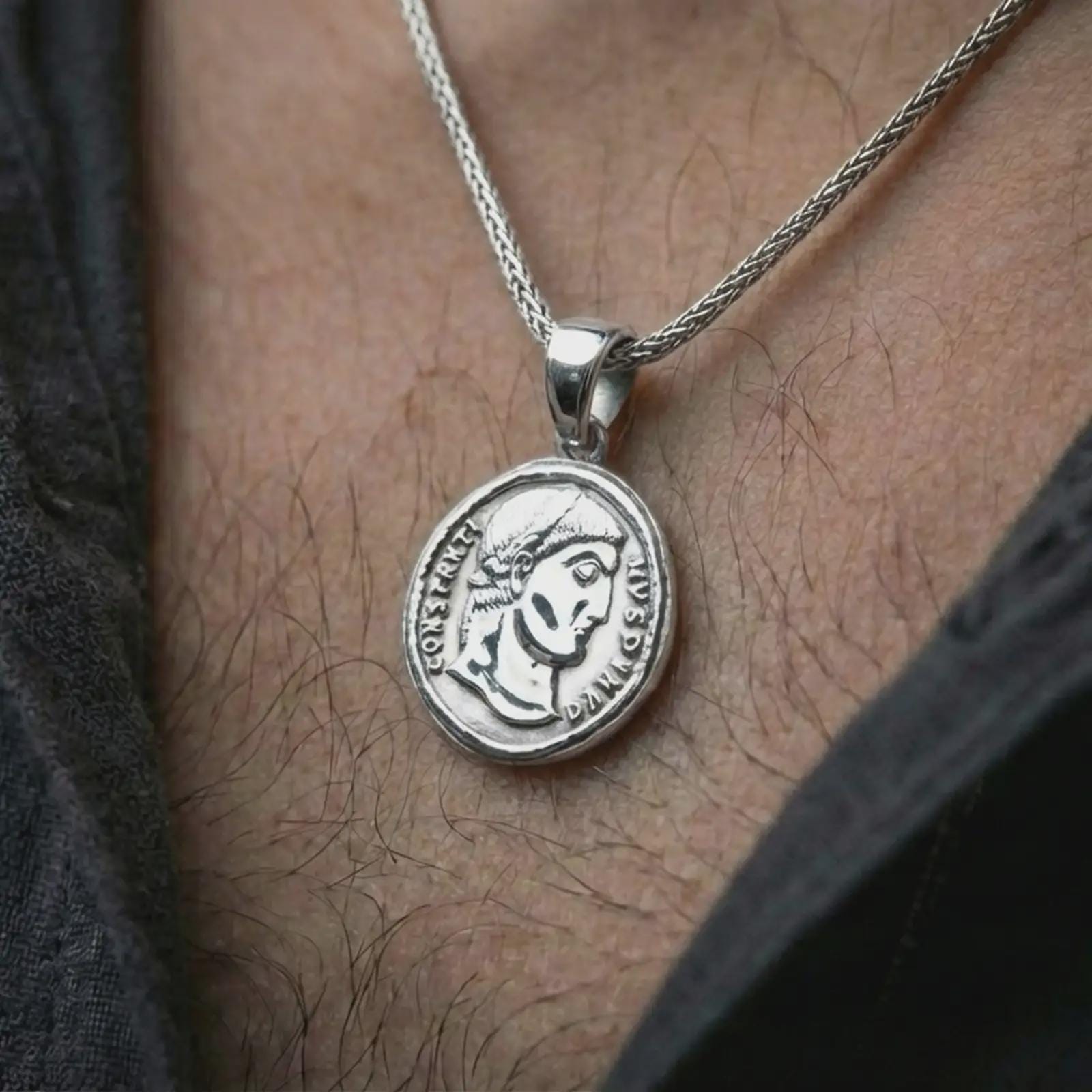 Polished silver Emperor Constans coin pendant necklace worn on the neck, shown in a clean model shot with the classical Roman emperor medallion centered for a refined antiquity-inspired look.