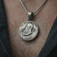 Load image into Gallery viewer, Oxidized heraldic eagle coin pendant necklace worn on the neck, styled in a dark lifestyle image that presents the imperial medallion as a bold symbolic statement piece.
