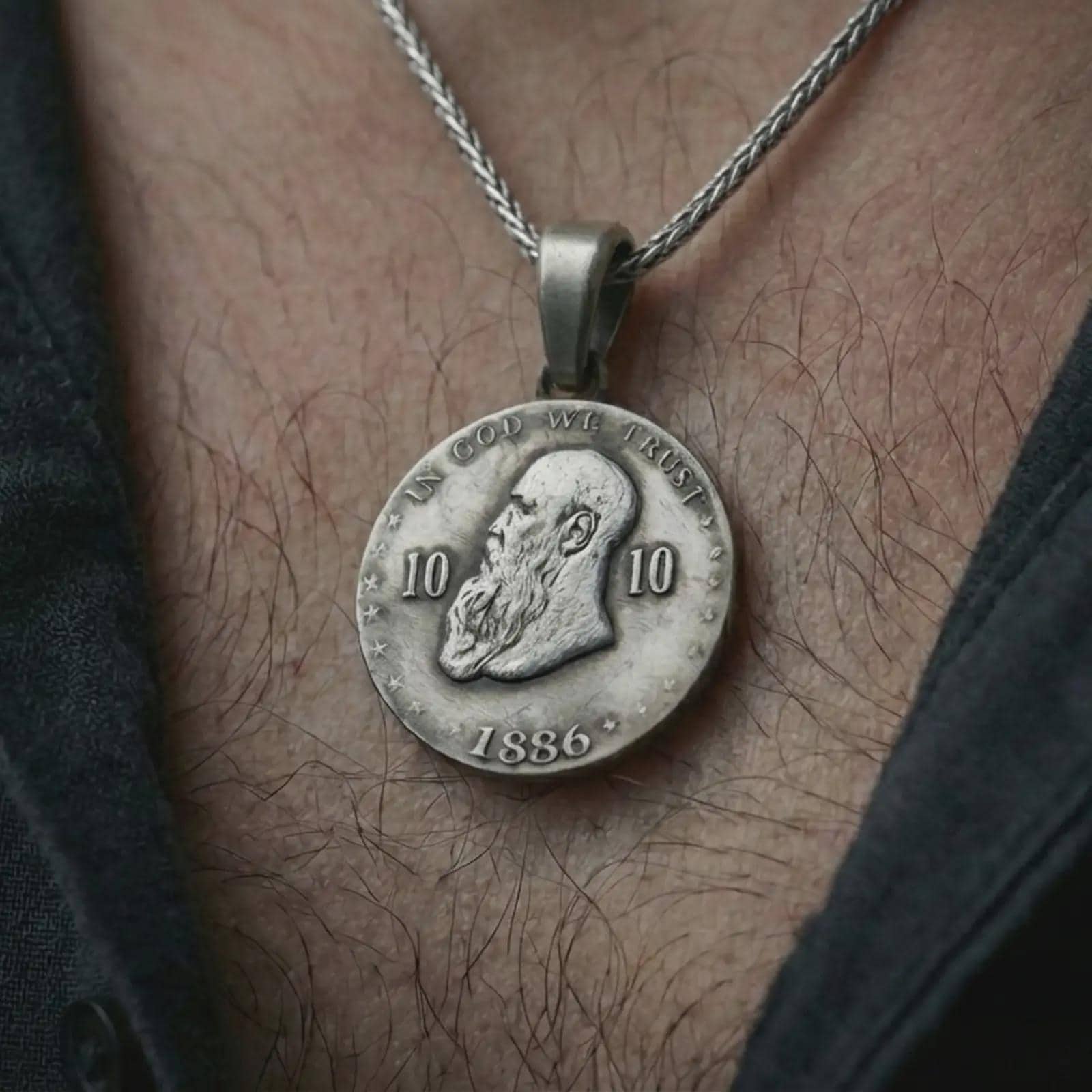 Oxidized heraldic eagle coin pendant necklace worn on the neck, styled in a dark lifestyle image that presents the imperial medallion as a bold symbolic statement piece.