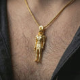 Load image into Gallery viewer, Gold plated Ra amulet pendant necklace worn on the neck, captured in a premium lifestyle composition that highlights the sun god motif as a distinctive heritage jewelry accent.
