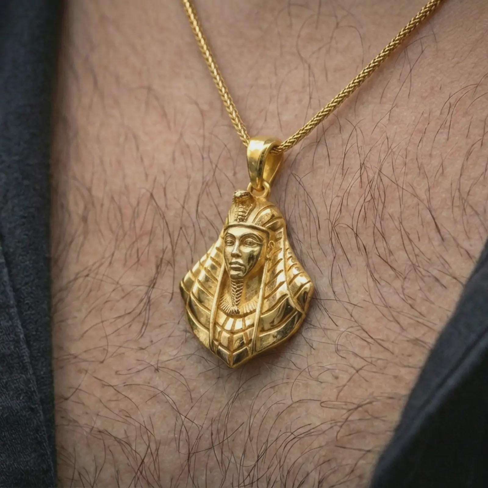 Gold plated Tutankhamun pendant necklace worn on the neck, captured in a premium lifestyle composition that highlights the royal Egyptian motif as a distinctive heritage jewelry accent.