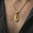 Load image into Gallery viewer, Gold plated Tutankhamun pharaoh pendant necklace worn on the neck, captured in a premium lifestyle composition that highlights the royal pharaoh motif as a distinctive heritage jewelry accent.
