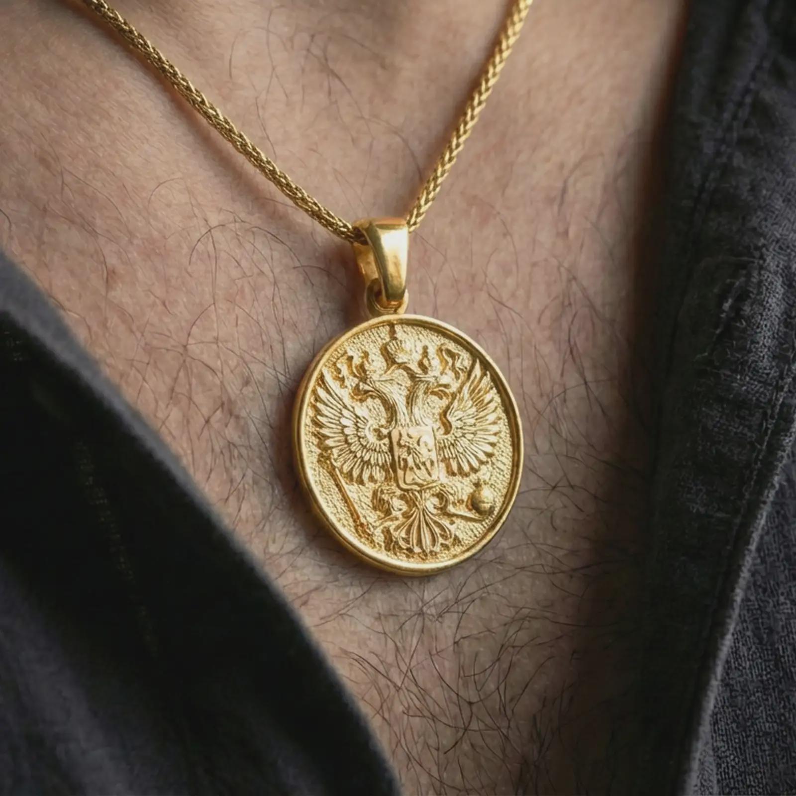 Gold plated double headed eagle pendant necklace worn on the neck, captured in a premium lifestyle composition that highlights the imperial eagle motif as a distinctive symbolic jewelry accent.