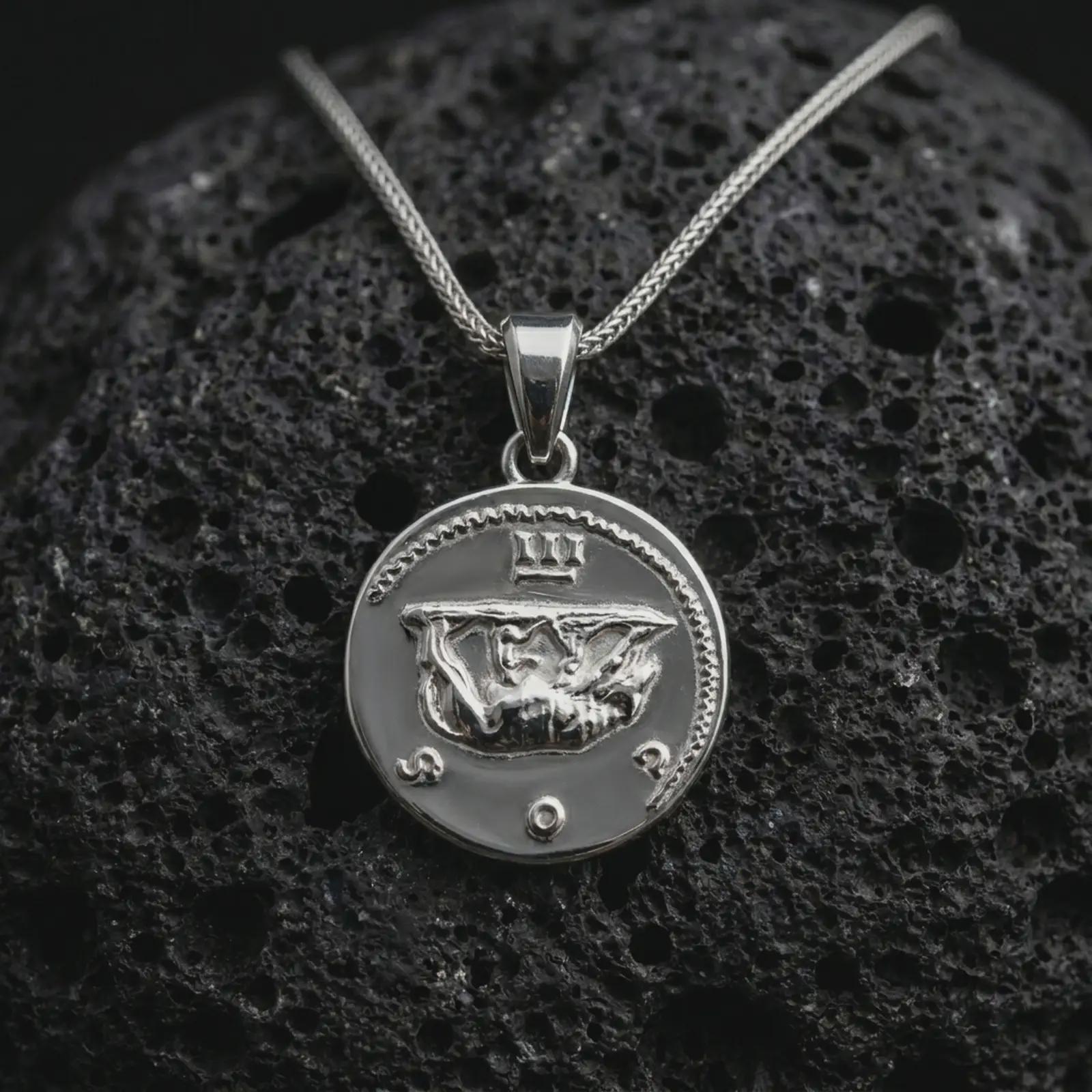 Polished silver Emperor Augustus coin pendant necklace displayed on dark volcanic rock, shown in a premium close-up image that highlights the classical emperor portrait and antique Roman coin texture.