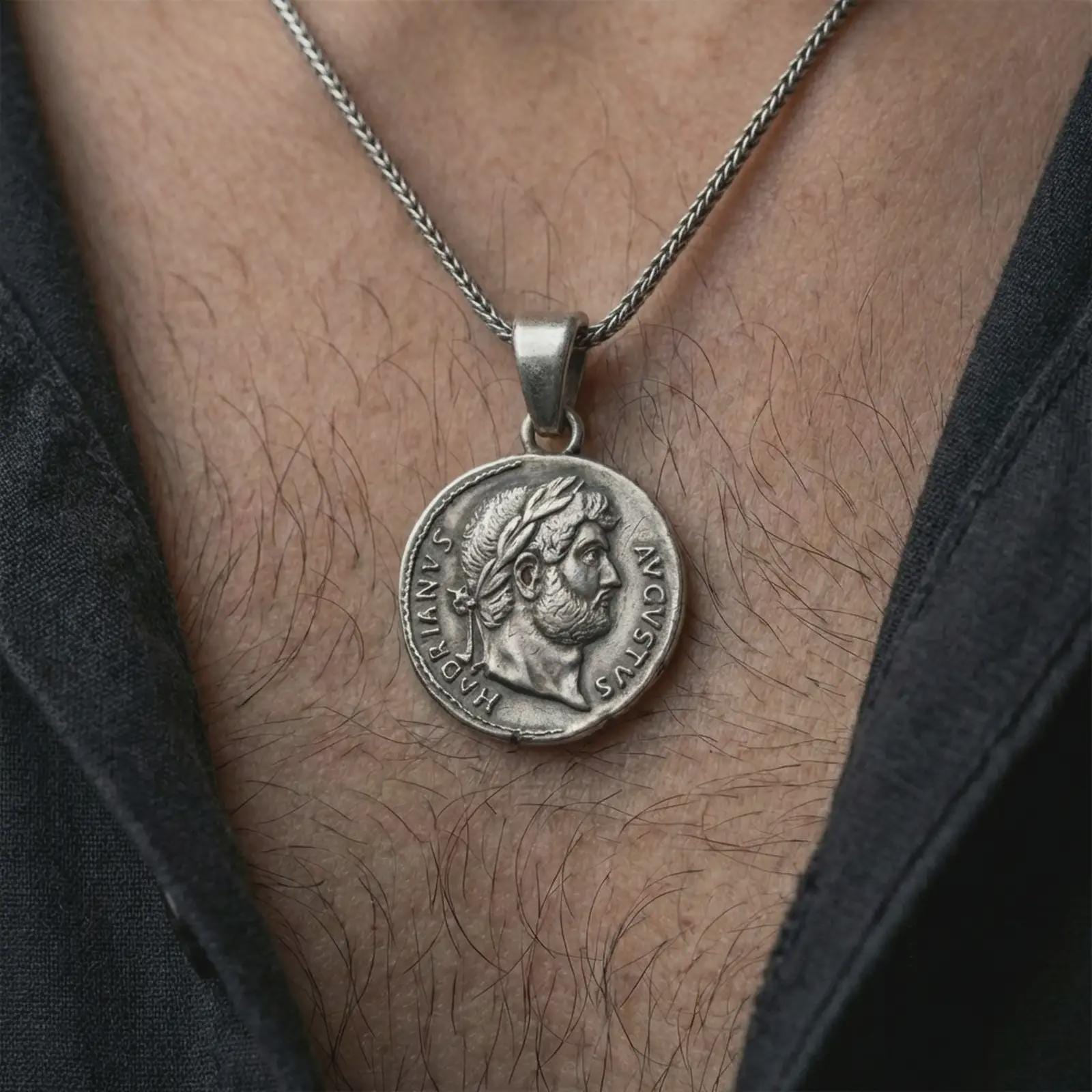 Oxidized Emperor Augustus coin pendant necklace worn on the neck, styled in a dark lifestyle image that presents the ancient Roman coin as a bold historical statement piece.