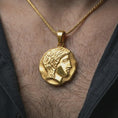 Load image into Gallery viewer, Gold plated ancient Greek coin pendant necklace worn on the neck, captured in a premium lifestyle composition that highlights the female profile motif as a distinctive heritage jewelry accent.
