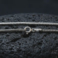 Load image into Gallery viewer, Polished silver Italian foxtail chain necklace on textured volcanic rock, centered macro jewelry photo with detailed wheat chain texture and bright silver highlights.
