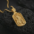 Load image into Gallery viewer, Gold plated Saint Barbara pendant necklace on textured volcanic rock, premium close-up studio composition emphasizing the crowned saint, cross, and tower symbolism.

