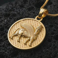 Load image into Gallery viewer, Gold plated Assyrian Lamassu pendant necklace on textured volcanic rock, premium close-up studio composition emphasizing the winged bull figure, patterned background, and ancient symbolism.
