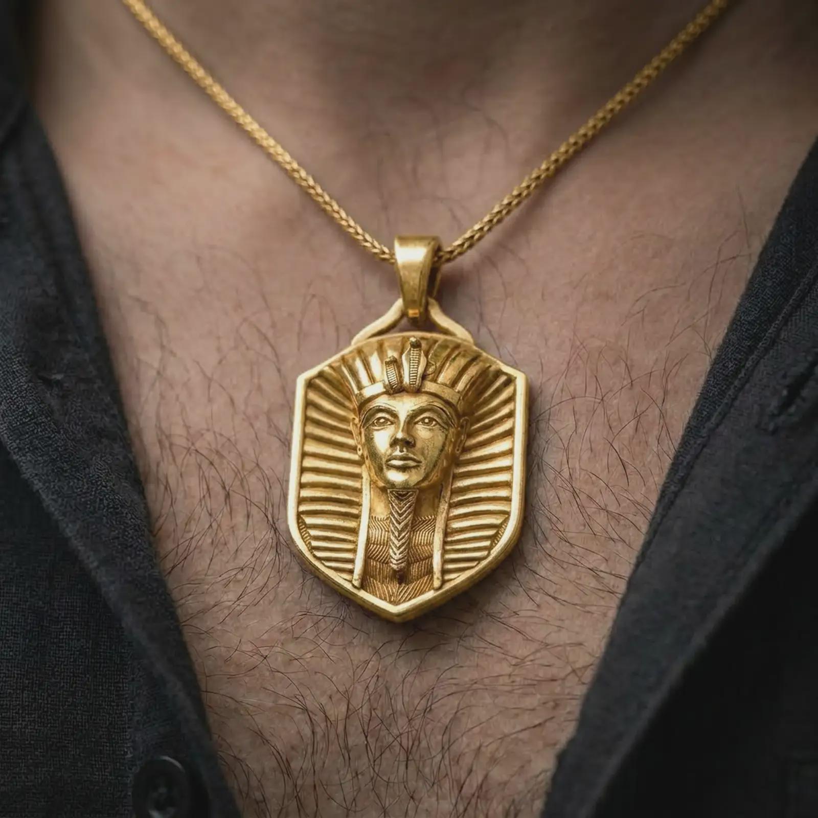 Gold plated pharaoh shield pendant necklace worn on the chest, premium lifestyle jewelry photo with the ancient Egypt pendant centered on a spiga chain.