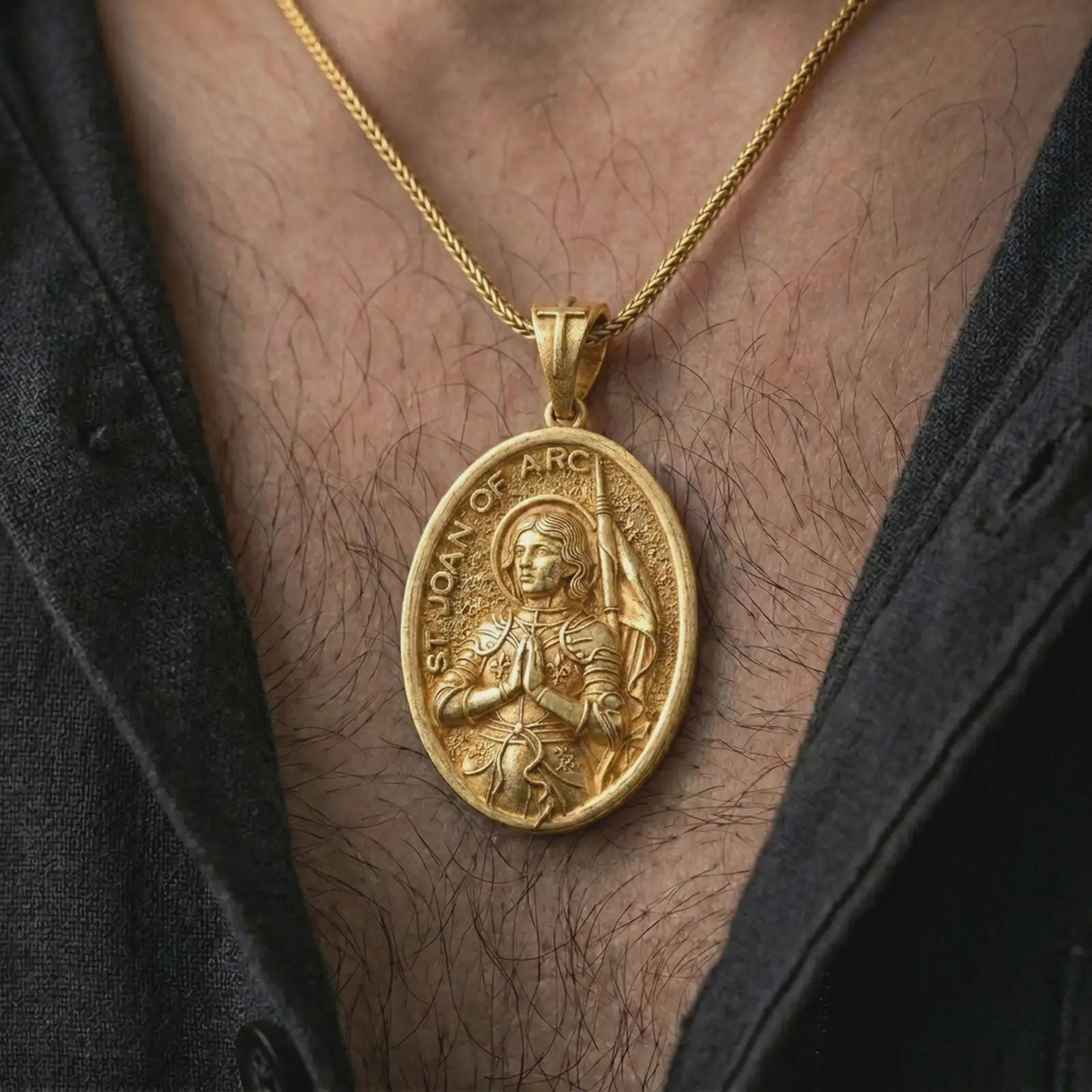 Gold plated Saint Joan of Arc pendant necklace worn on the chest, premium lifestyle jewelry photo with the Catholic saint medal centered on a spiga chain.