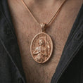 Load image into Gallery viewer, Rose gold plated Saint Joan of Arc pendant necklace worn on the chest, close-up lifestyle shot featuring the sacred Joan of Arc design with warm rose gold tones.

