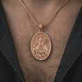 Load image into Gallery viewer, Rose gold plated Saint Patrick pendant necklace worn on the chest, close-up lifestyle shot featuring the sacred Saint Patrick design with warm rose gold tones.
