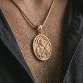 Load image into Gallery viewer, Rose gold plated Saint Andrew pendant necklace worn on the chest, close-up lifestyle shot featuring the sacred Saint Andrew design with warm rose gold tones.
