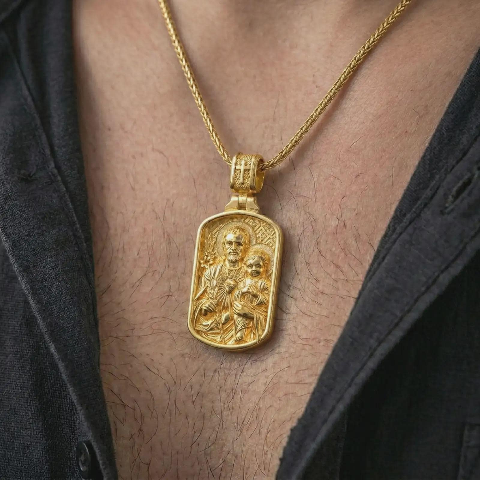 Gold plated Saint Joseph and Jesus pendant necklace worn on the chest, premium lifestyle jewelry photo with the Catholic Saint Joseph medal centered on a spiga chain.