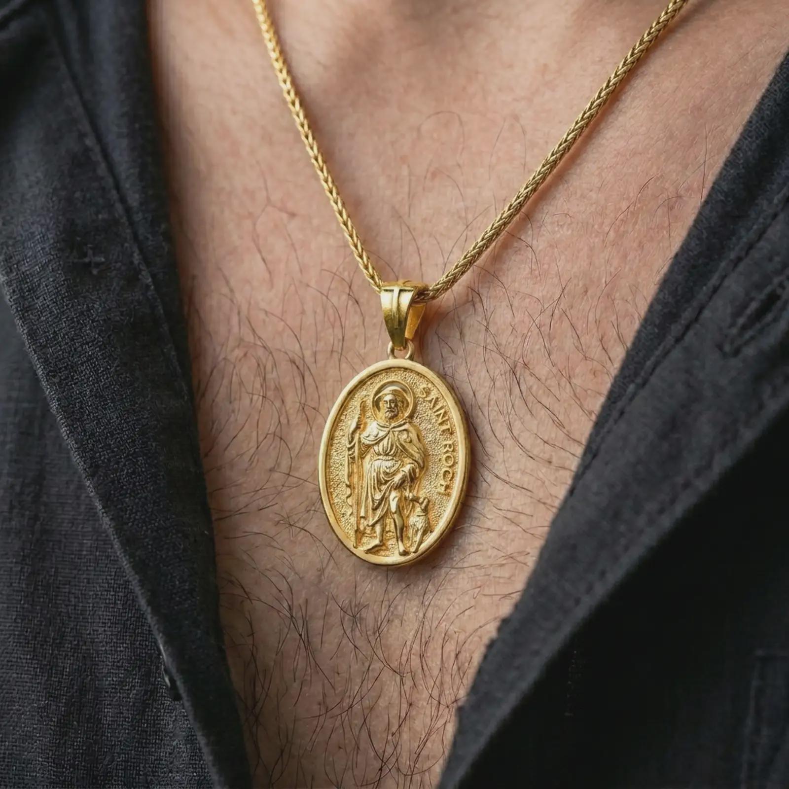 Gold plated Saint Roch pendant necklace worn on the chest, premium lifestyle jewelry photo with the Saint Roch medal centered on a spiga chain.